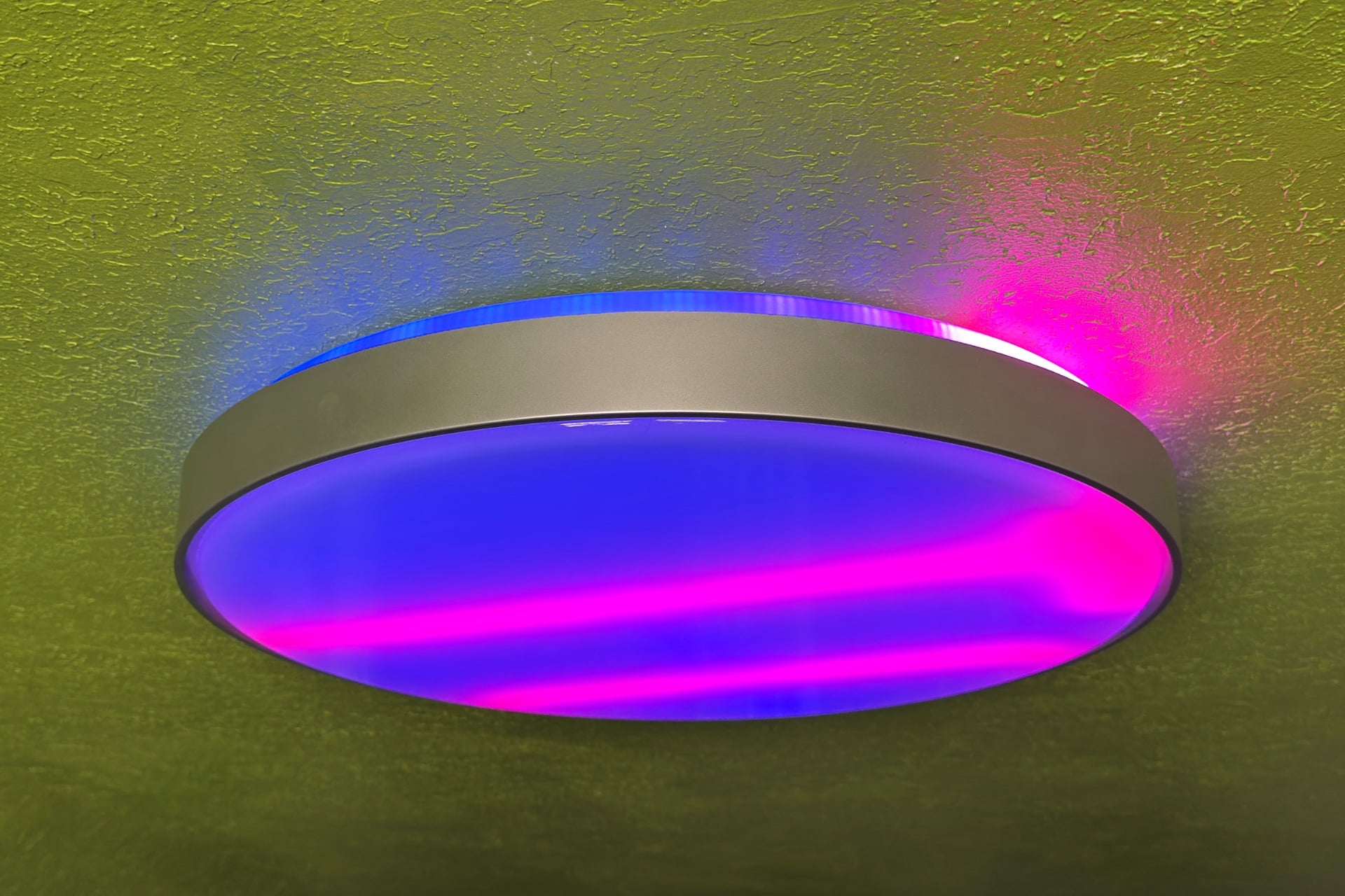 Govee Ceiling Light Ultra viewed from an angle, showing the upper ring of lights, which match the color and position of the main lights.