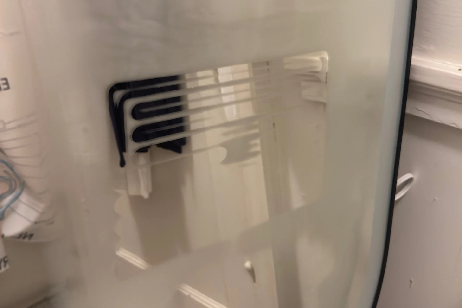 Closeup of the Lifx Smart Mirror in defog mode, with the pattern of its heating element revealed where condensation has dissipated.