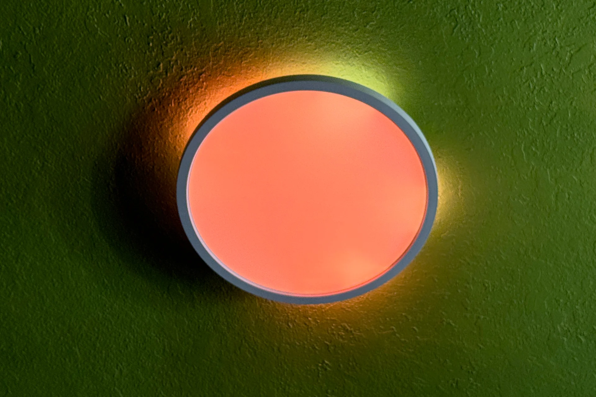 Nanoleaf Smart Multicolor ceiling light shhowing a peach and yellow effect