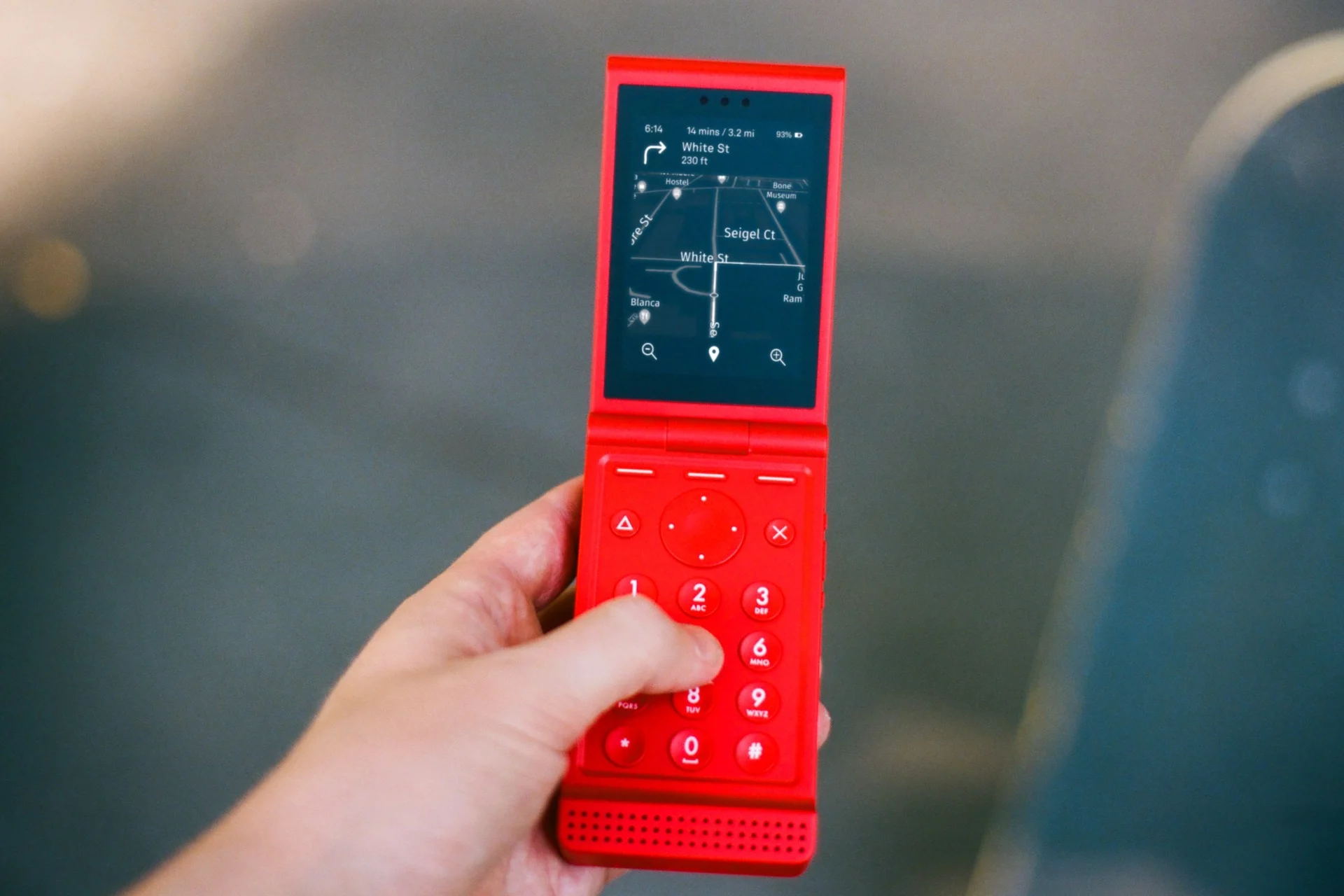 A Light Flip phone in red showing Google maps