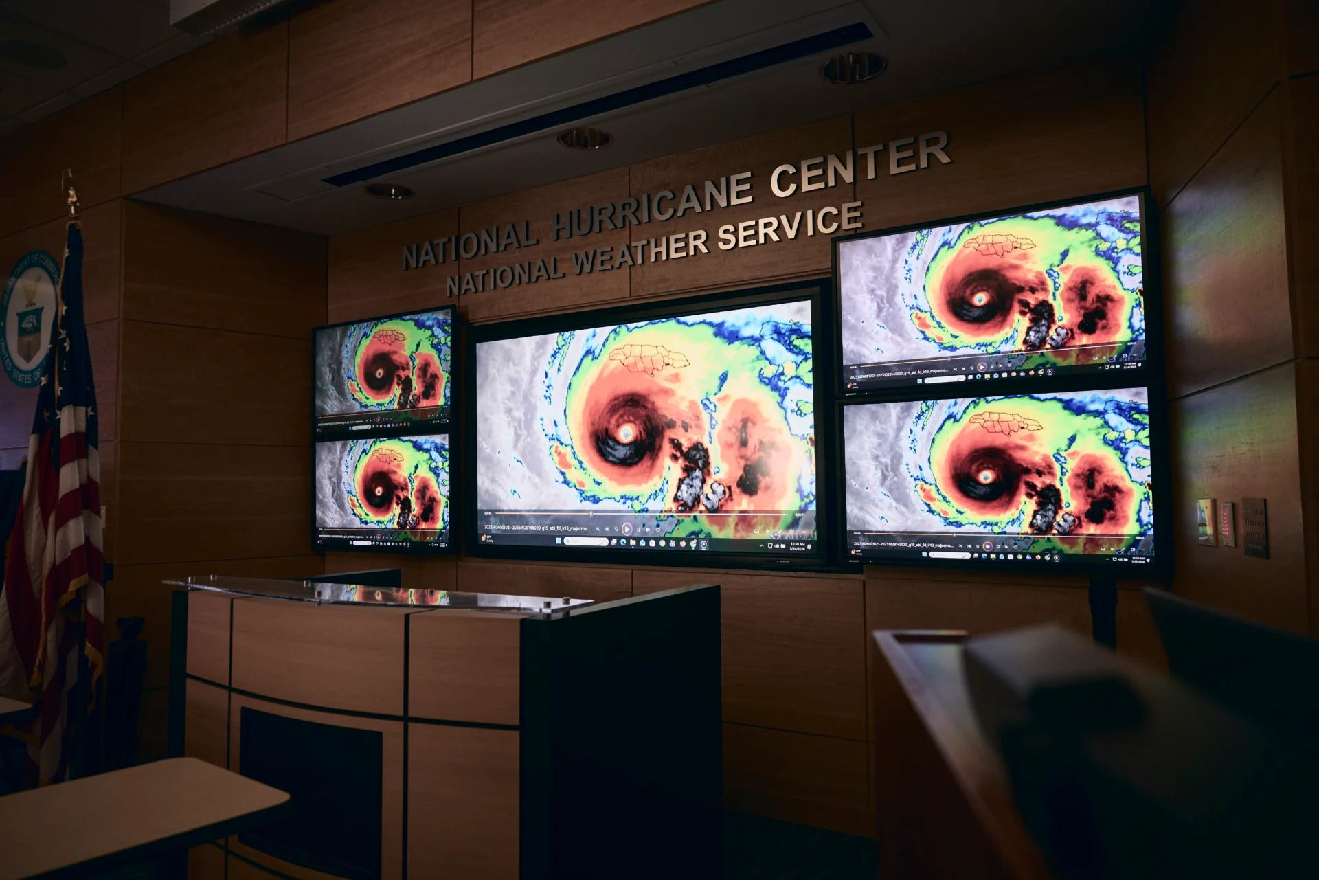 computer screens showing satellite imagery of Hurricane Melissa at the National Hurricane Center
